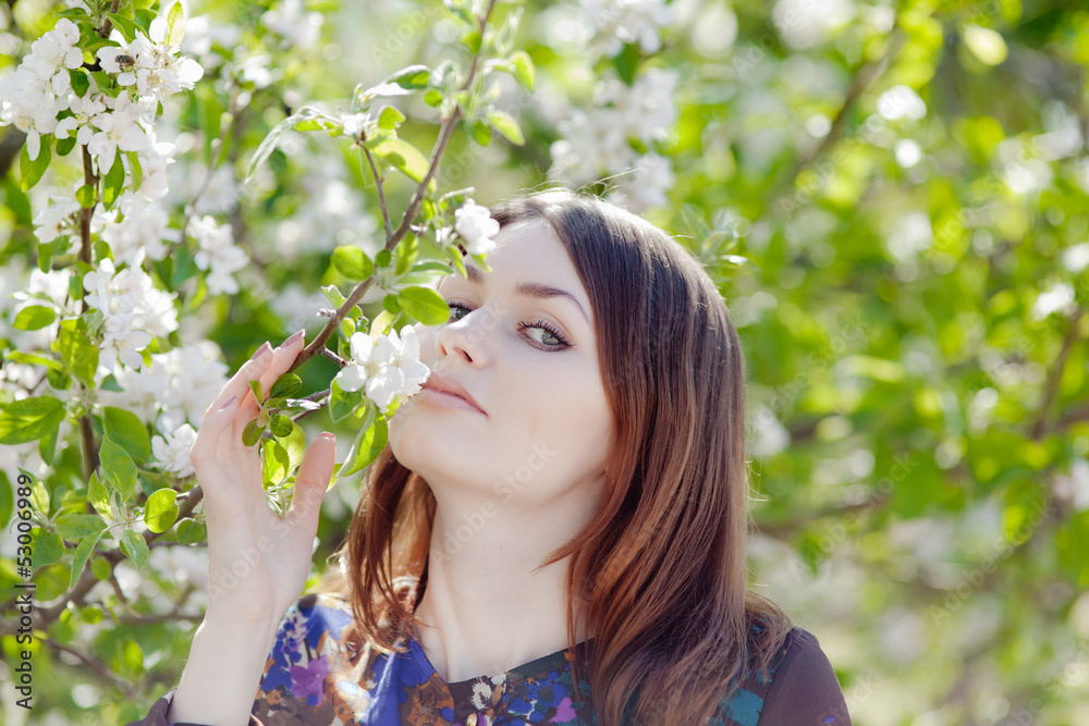Girl sniffs blossoming apple-tree Girl sniffs blossoming apple-tree