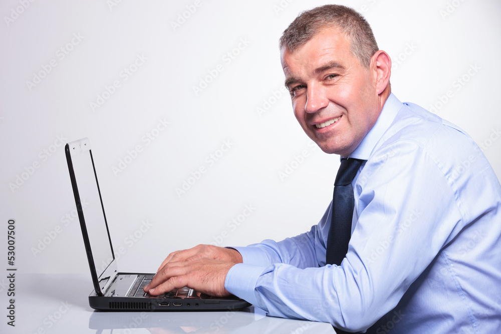 old business man working on his laptop old business man working on his laptop