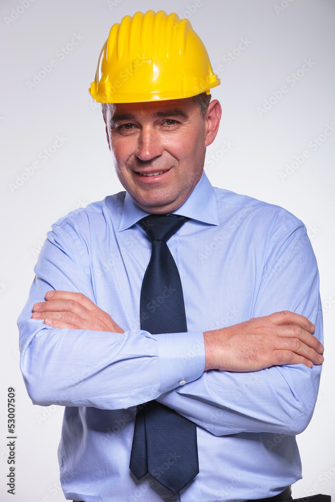 old engineer stands with hands folded old engineer stands with hands folded