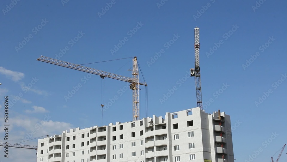 Tower cranes against blue sky, with clouds. Timelapse. Tower cranes against blue sky, with clouds. Timelapse.
