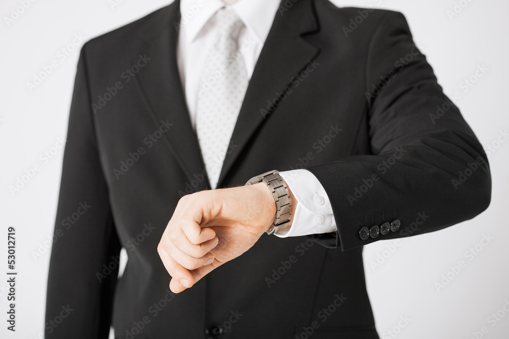 man looking at wristwatch