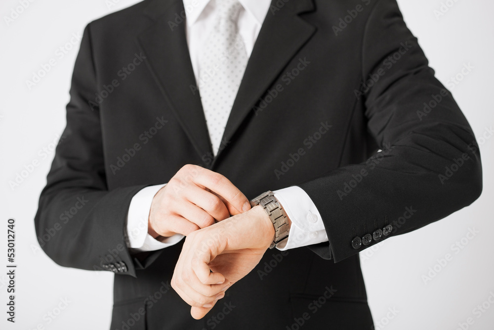 man looking at wristwatch