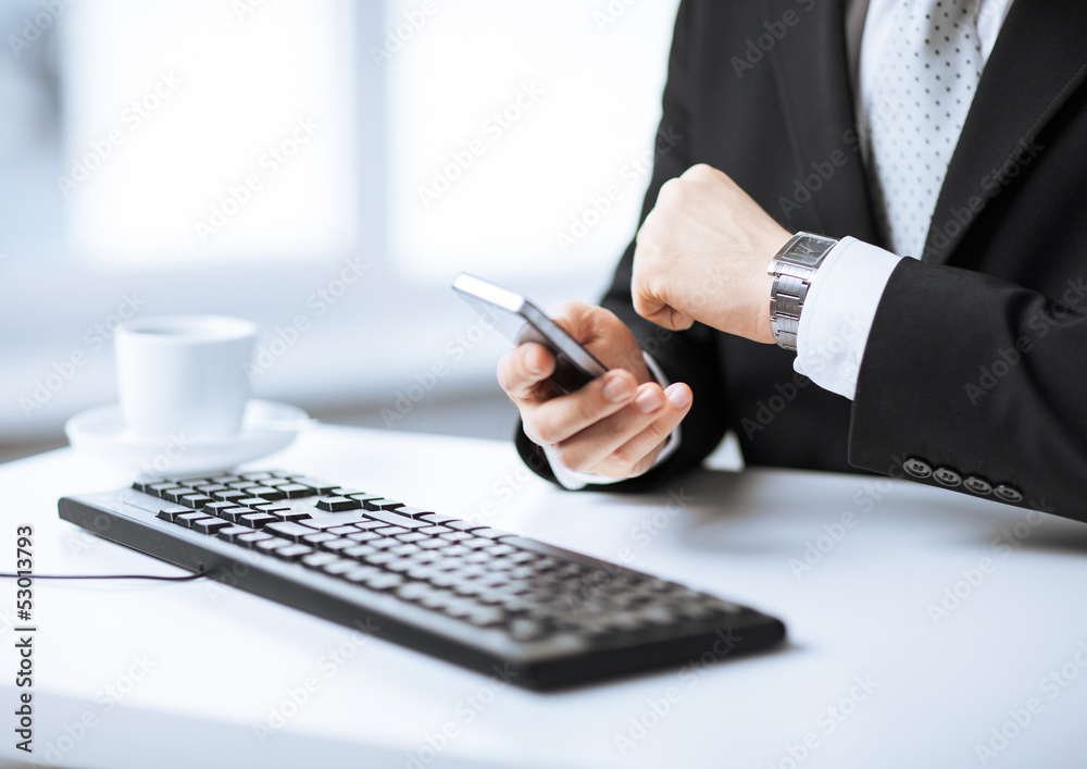 man hands with keyboard, smartphone and wristwatch man hands with keyboard, smartphone and wristwatch