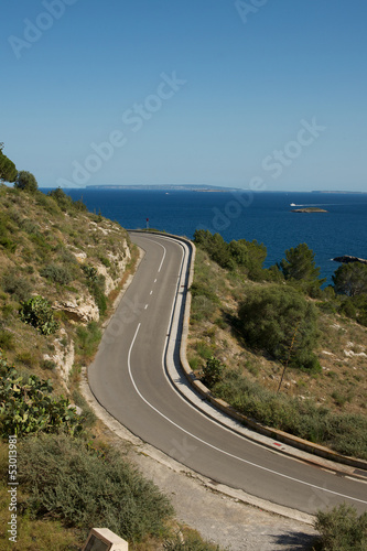 Picture of a road, with a beautiful sea view in the background