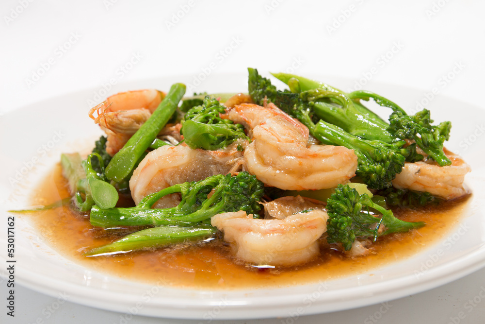 Prawns with broccoli fried sauce on white dish Prawns with broccoli fried sauce on white dish