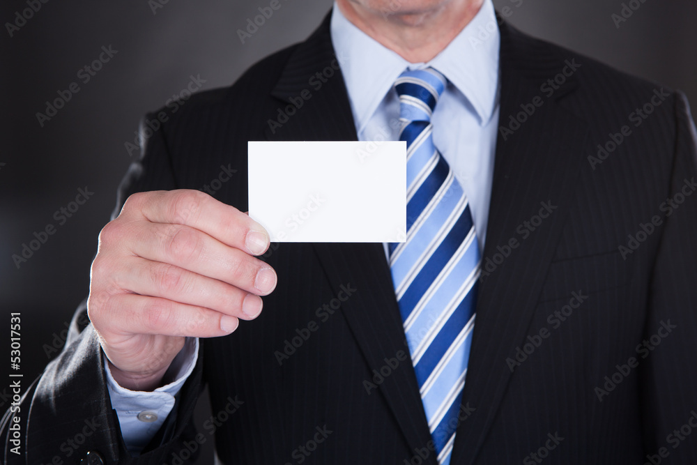 Close-up Of Businessman Holding Visiting Card