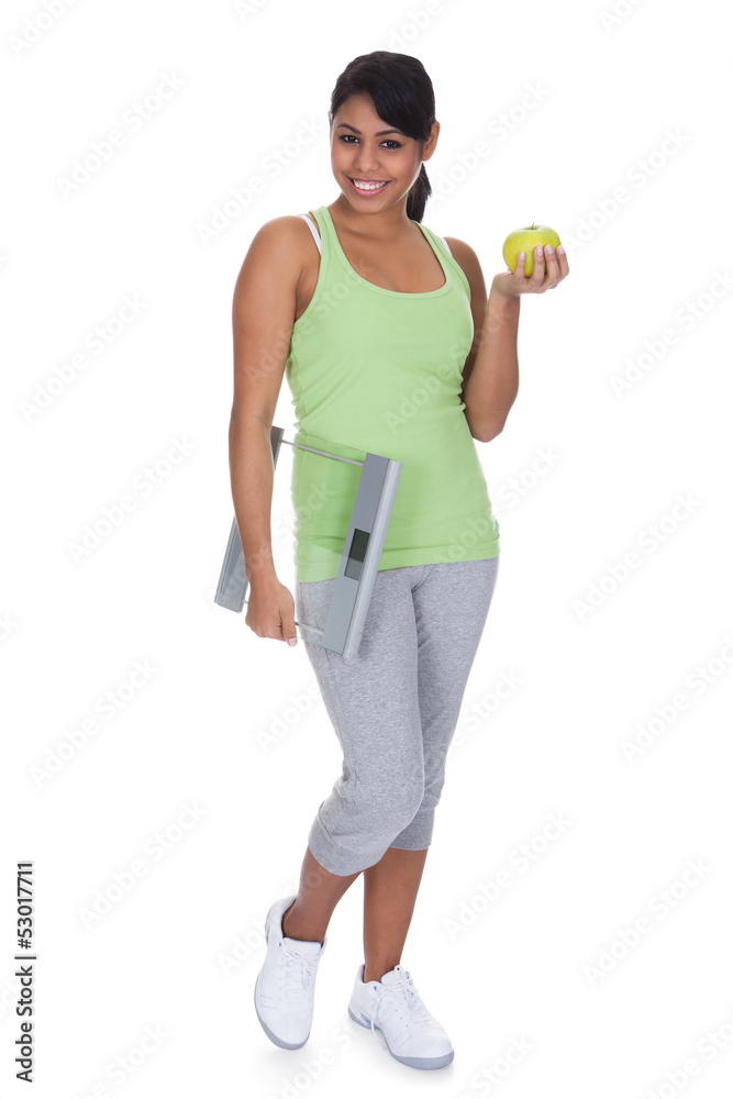 Portrait Of Woman Holding A Weighing Scale And An Apple Portrait Of Woman Holding A Weighing Scale And An Apple