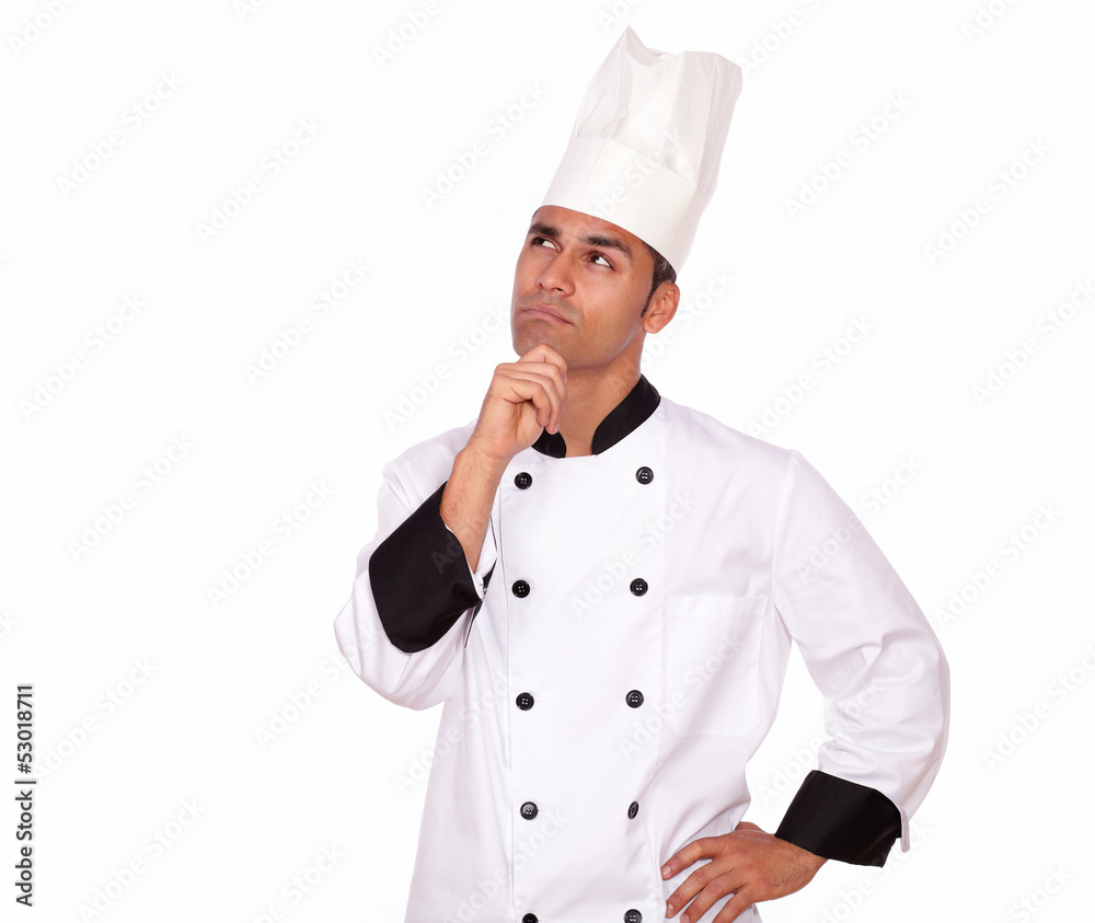 Pensive professional chef looking to right up Pensive professional chef looking to right up