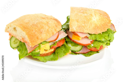 Sliced sandwich with ham and vegetables isolated on white