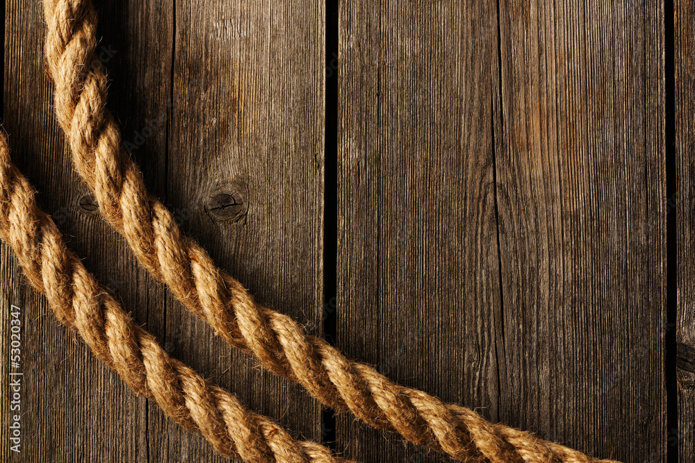 Fototapeta premium Rope over wooden background