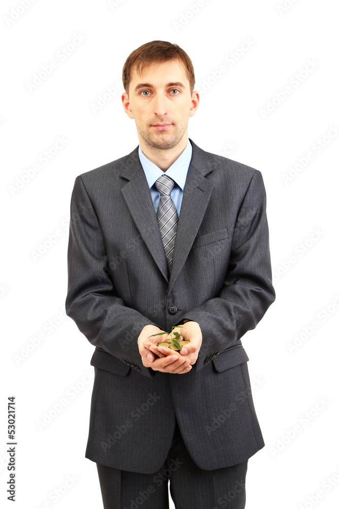 Young businessman with coins and plant isolated on white.