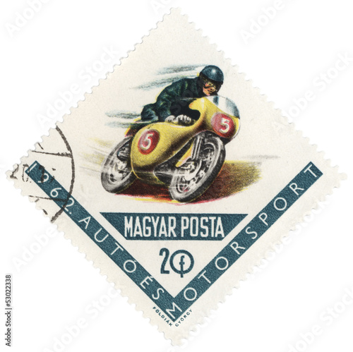 Riding motorcyclist on post stamp