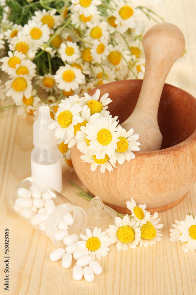 Medicine chamomile flowers on wooden table