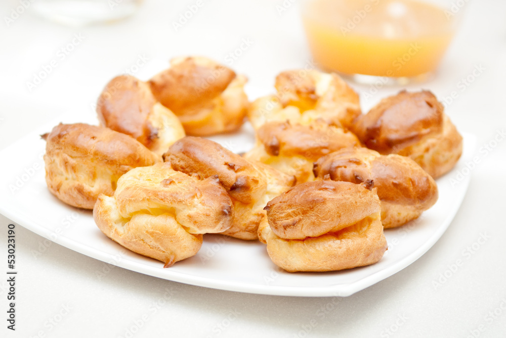 delisious profiteroles on the white plate