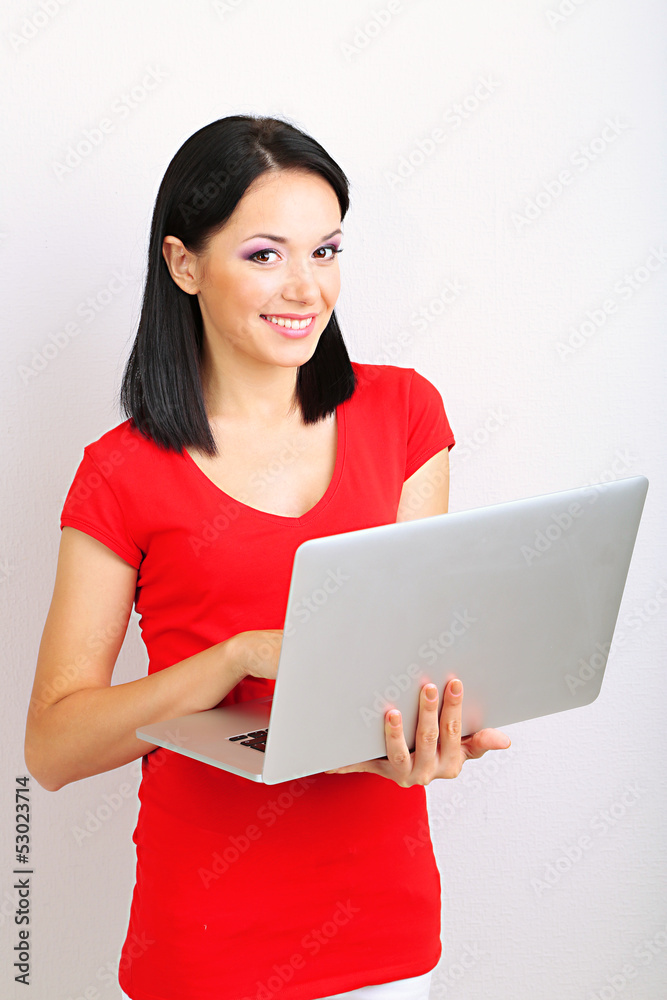Beautiful young woman with notebook in room Beautiful young woman with notebook in room