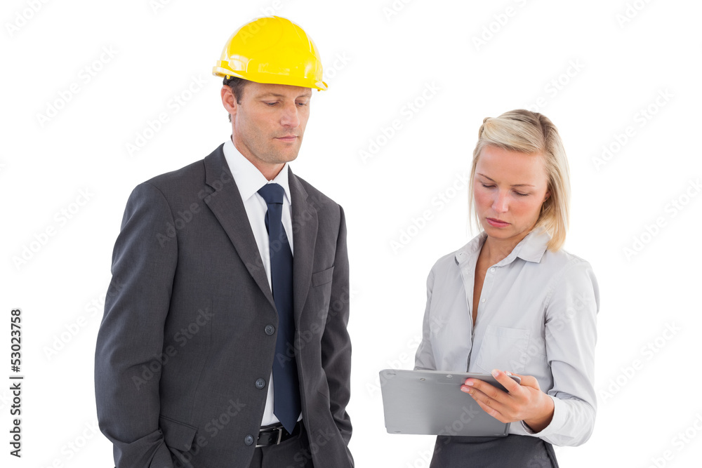 Two architects looking at clipboard Two architects looking at clipboard