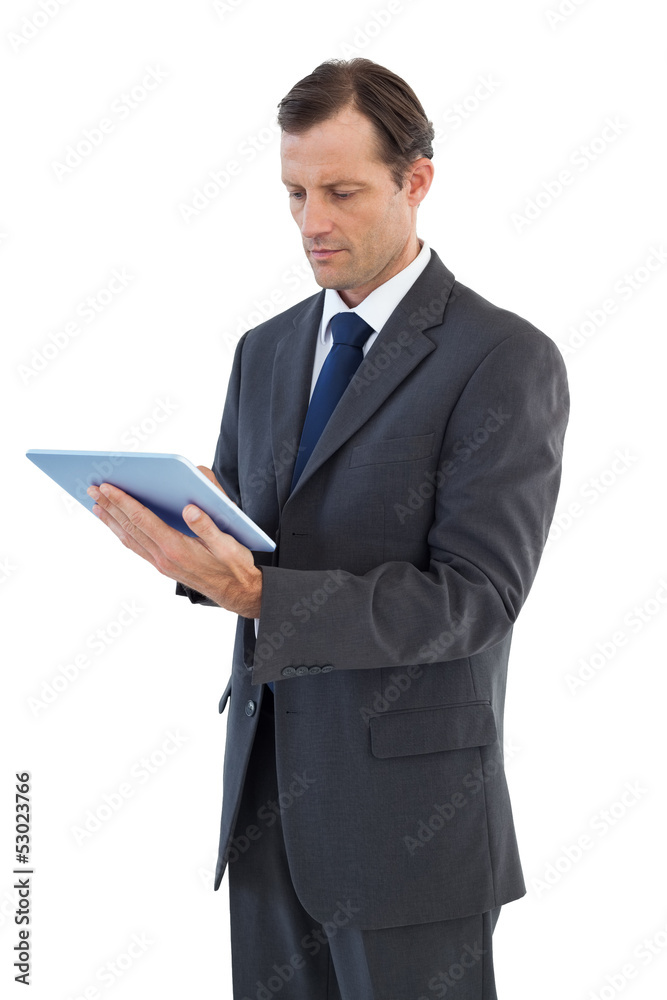 Charismatic businessman holding a tablet pc Charismatic businessman holding a tablet pc