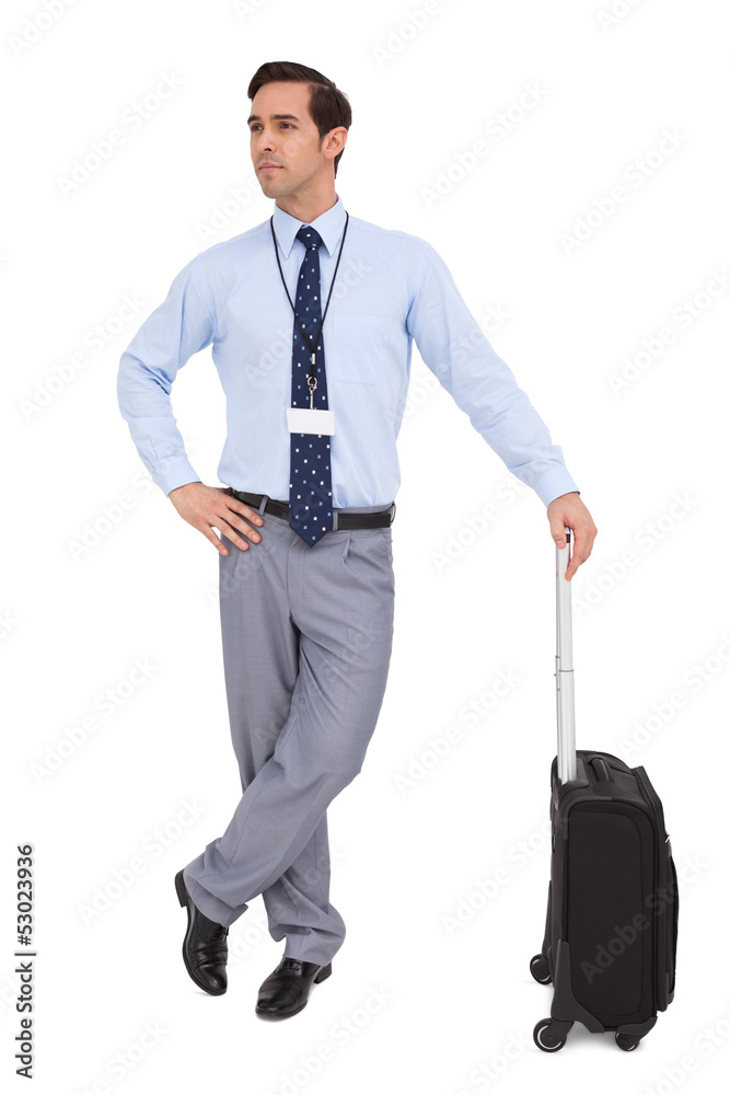 Serious businessman waiting with his suitcase Serious businessman waiting with his suitcase