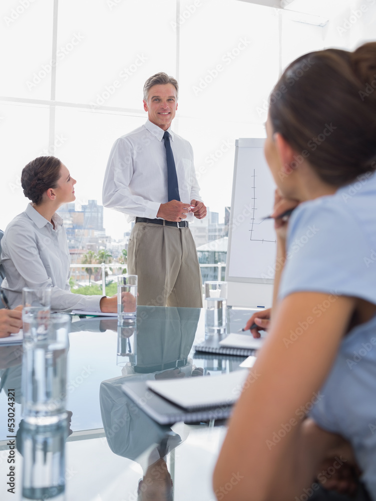 Fototapeta premium Businessman standing in front of colleagues