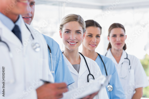 Smiling medical team in row