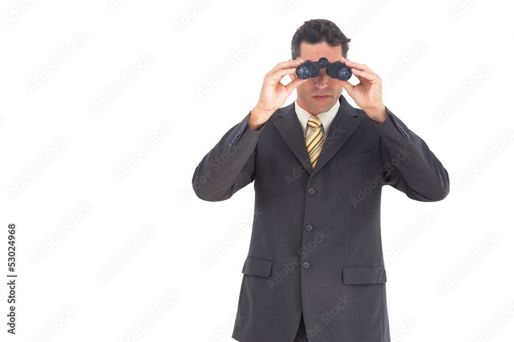 Businessman looking at the camera with binoculars Businessman looking at the camera with binoculars