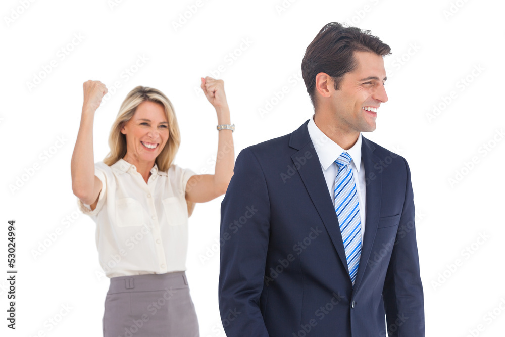 Businesswoman with raised arms and her coworker Businesswoman with raised arms and her coworker