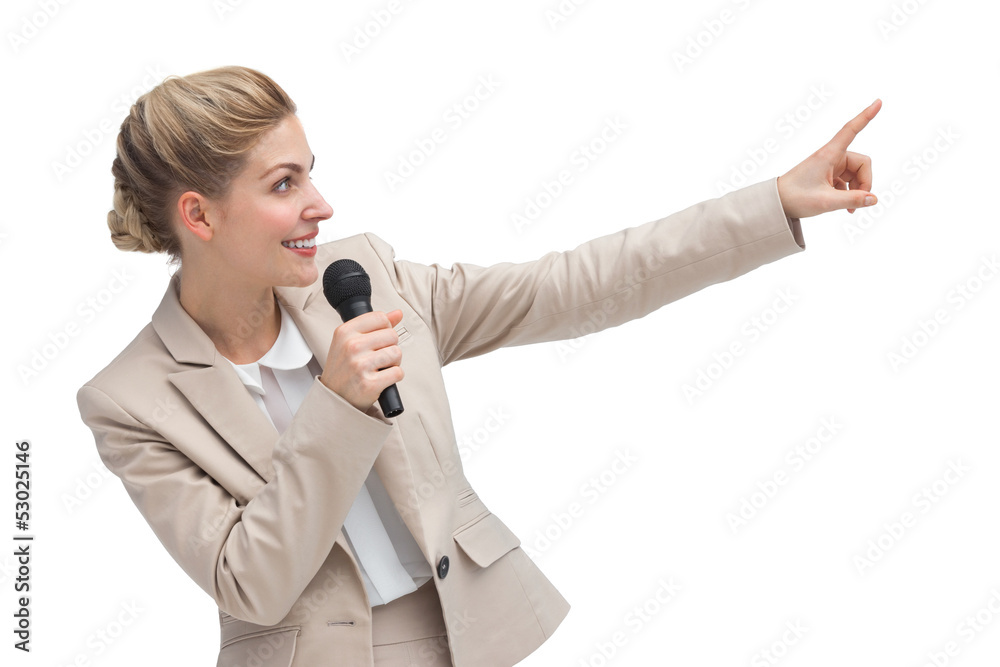 Businesswoman with microphone indicating something Businesswoman with microphone indicating something