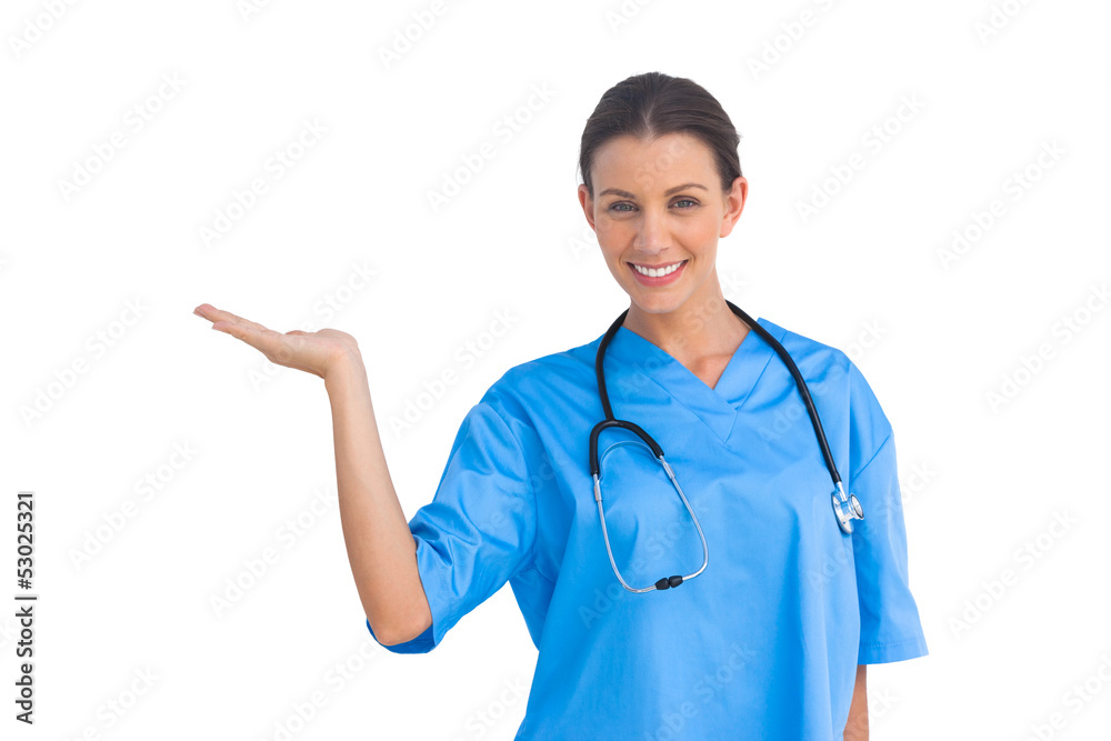 Surgeon holding up hand in presentation and smiling at camera Surgeon holding up hand in presentation and smiling at camera