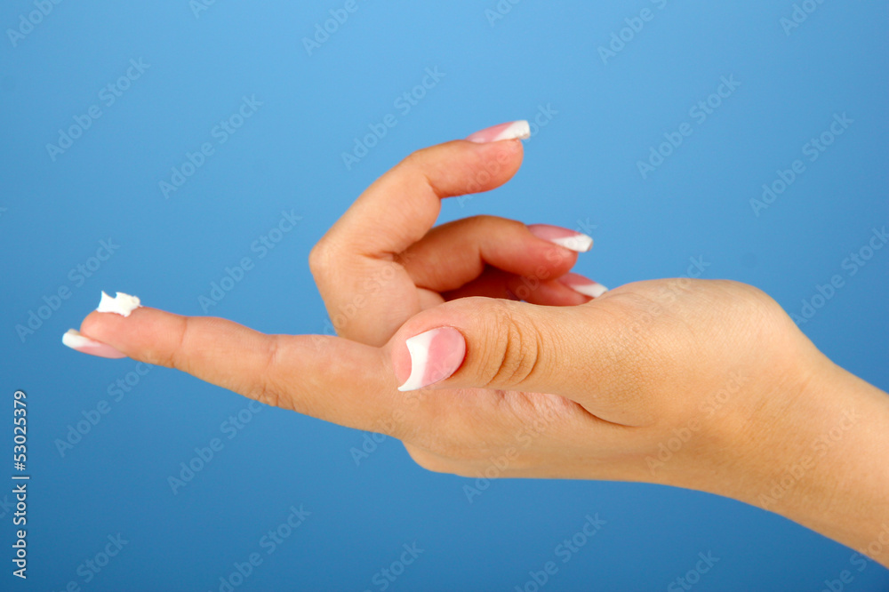 Woman with cream on hand, on color background Woman with cream on hand, on color background