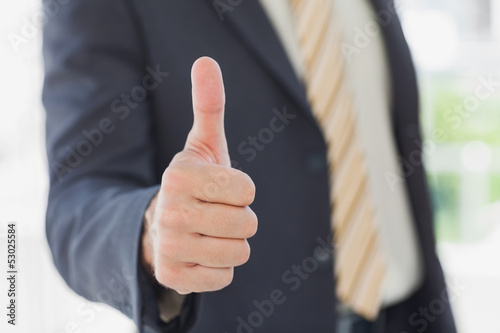 Businessman giving thumbs up