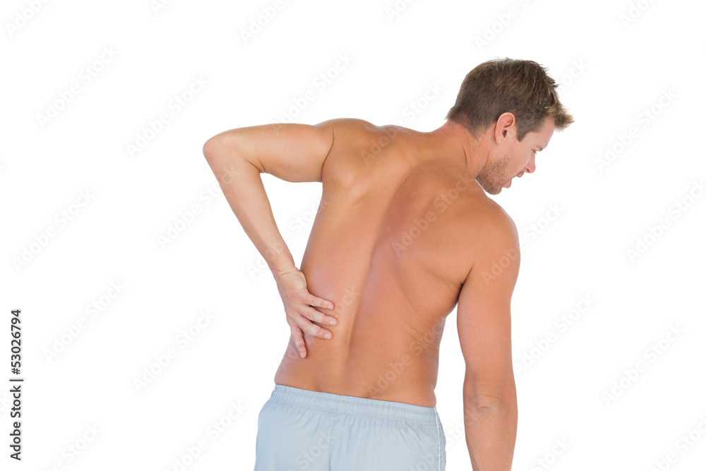 Man rubbing his back because of a back pain