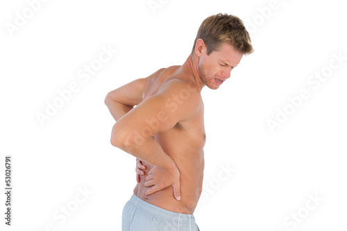 Topless man suffering from back pain