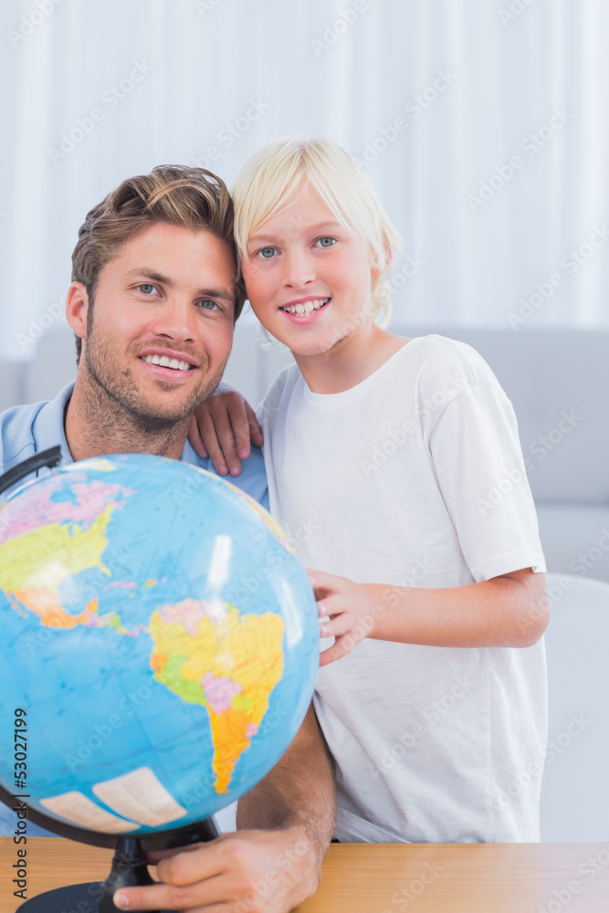 Fototapeta premium Father and his little boy looking at globe