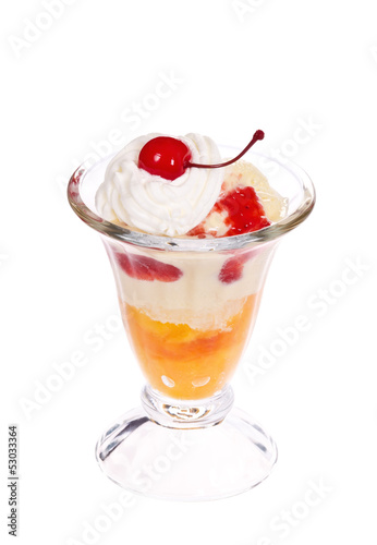 Peach melba ice cream with whipped cream and cherry on the top