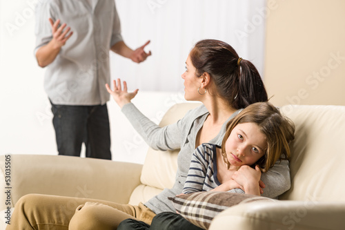 Arguing parents with upset little girl
