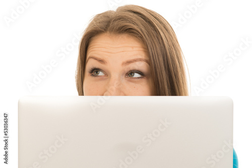 beautiful woman hiding behind a laptop