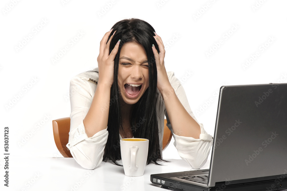 Woman screaming nervously at the laptop isolated on white. Woman screaming nervously at the laptop isolated on white.