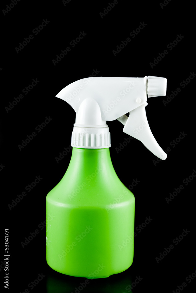 Green plastic sprayer isolated on black background Green plastic sprayer isolated on black background