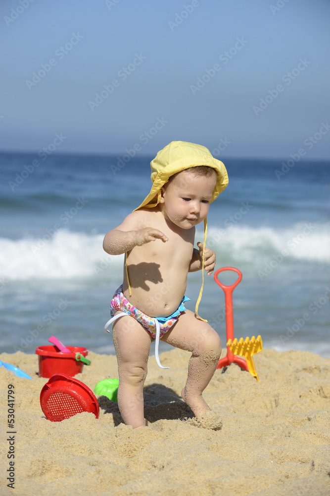 Baby walking in the sand on the beach Baby walking in the sand on the beach