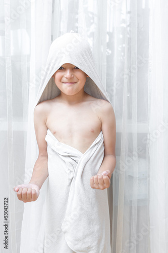Smiling little boy in towel