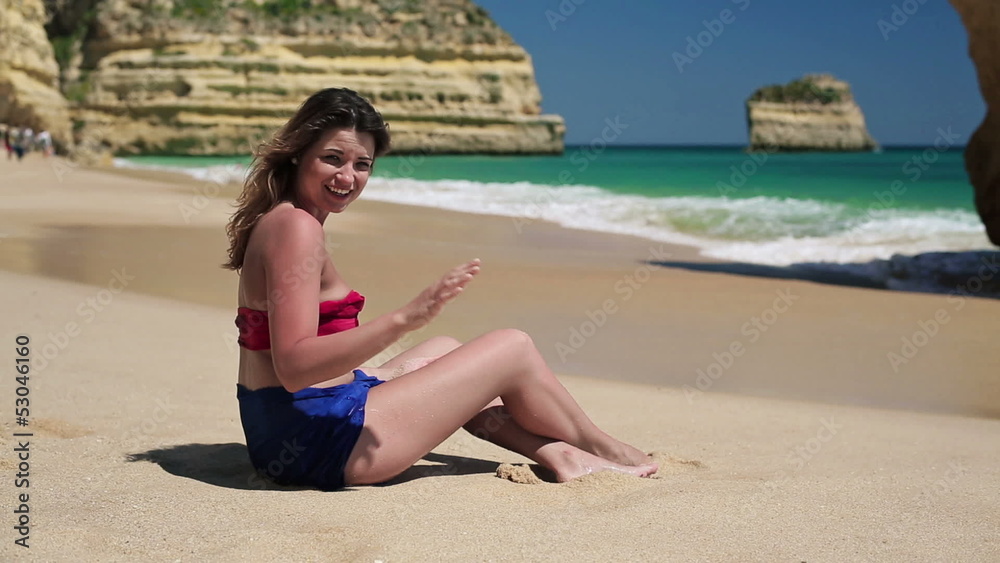 Young sexy woman waving had to camera on beautiful beach Young sexy woman waving had to camera on beautiful beach