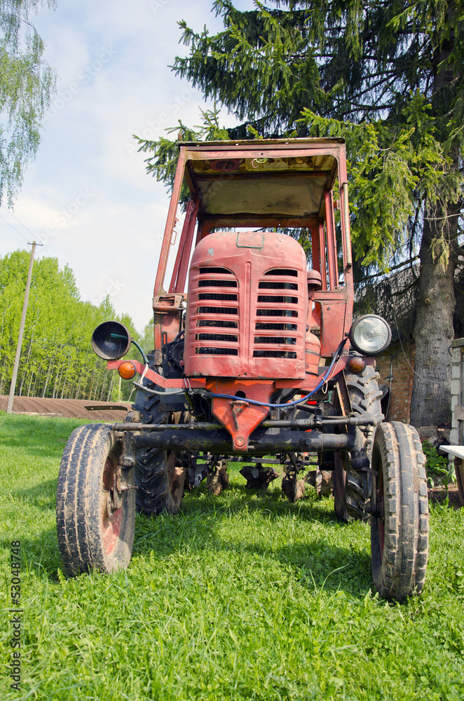 old red tractor on grass in farm old red tractor on grass in farm