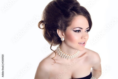 Beautiful woman with pearls and evening make-up isolated on whi