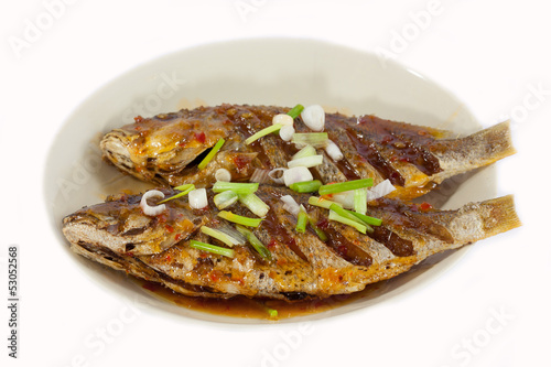 Fried fish on plate, isolated on white background