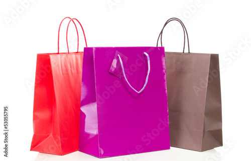 Three colorful shopping bags on white table