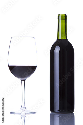 Glass with red wine and bottle of red wine