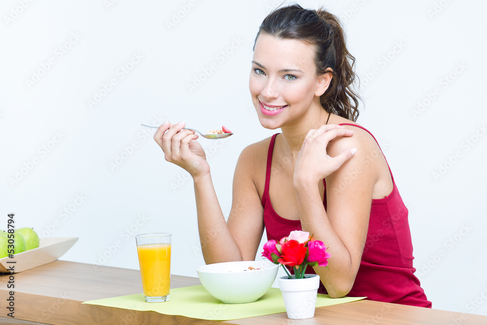 Young woman taking a breakfast cereal at home Young woman taking a breakfast cereal at home
