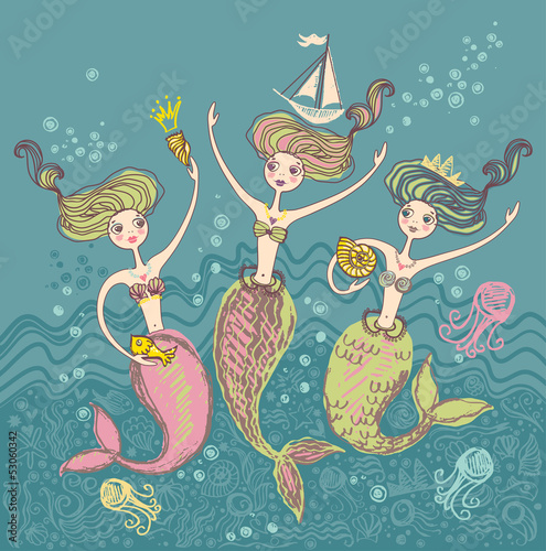 Three little funny mermaids playing in the sea waves.