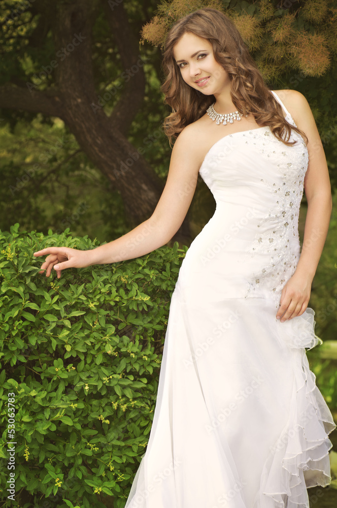 Beautiful bride with stylish make-up in white dress