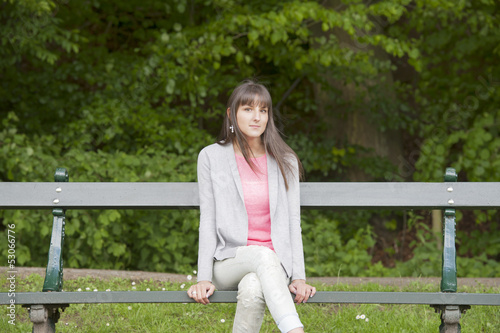 young woman seated on a bench in the park